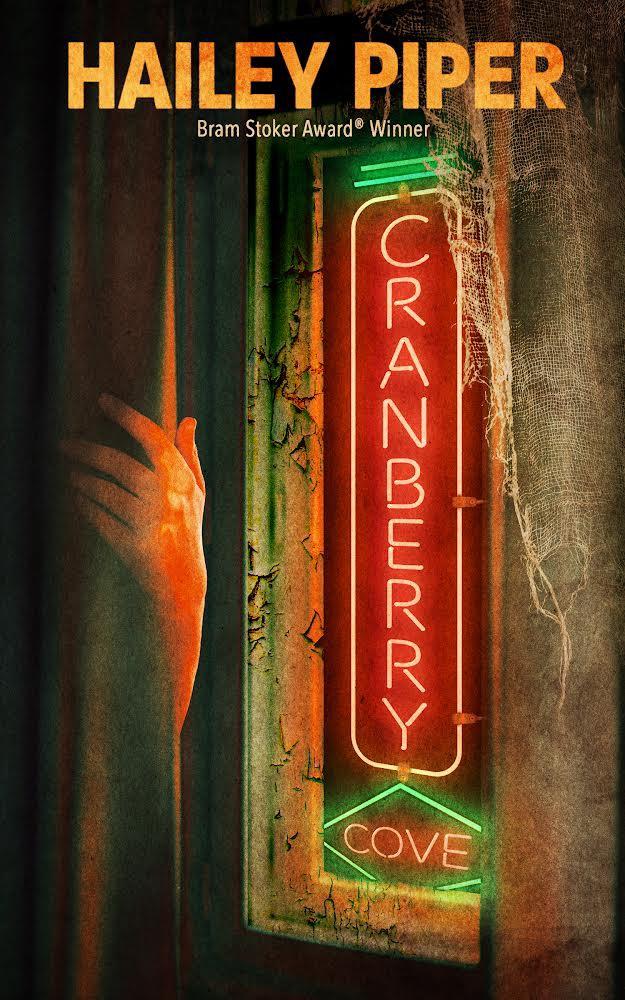 Cover art: a hand reaches from behind a dusty hotel curtain. Behind it, the glowing neon sign of Cranberry Cove peers through a window